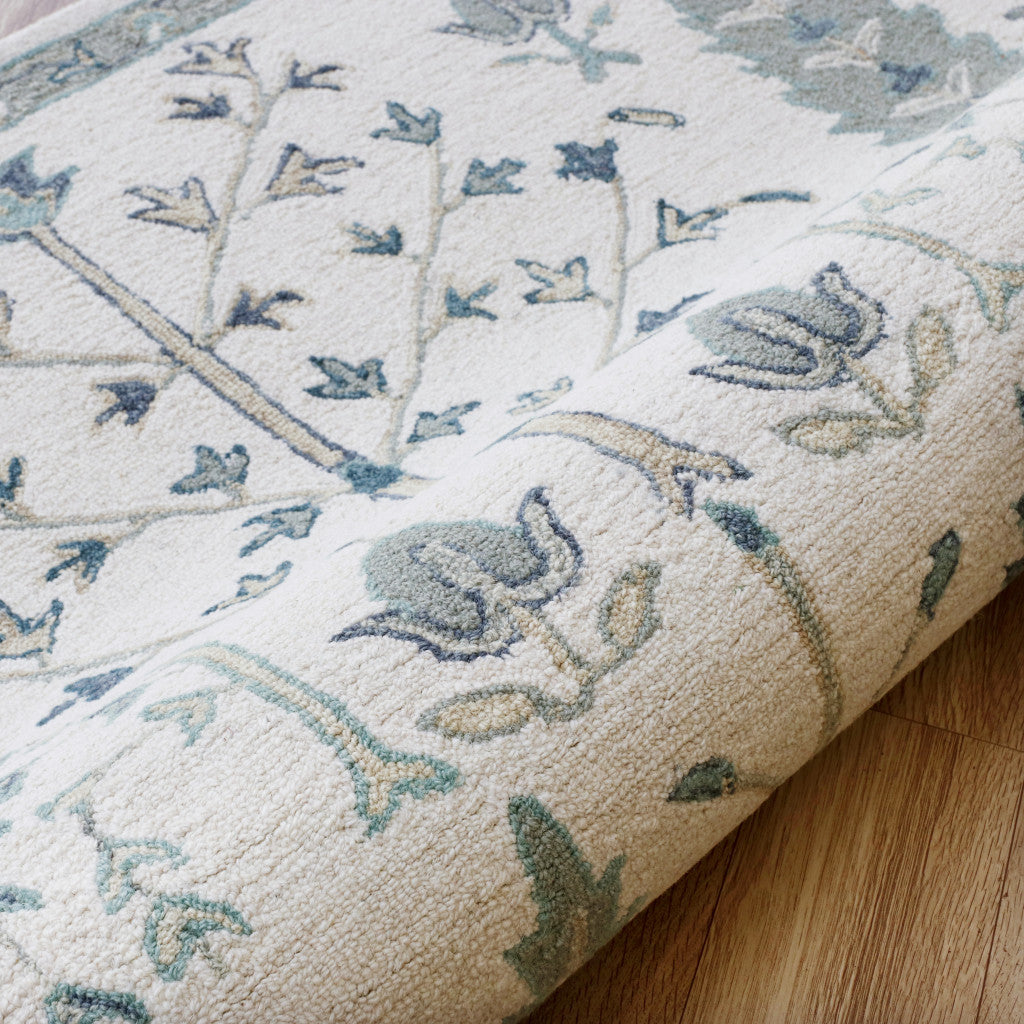 5' x 8' Ivory and Blue Wool Floral Hand Tufted Area Rug