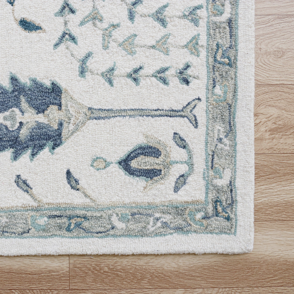 5' x 8' Ivory and Blue Wool Floral Hand Tufted Area Rug