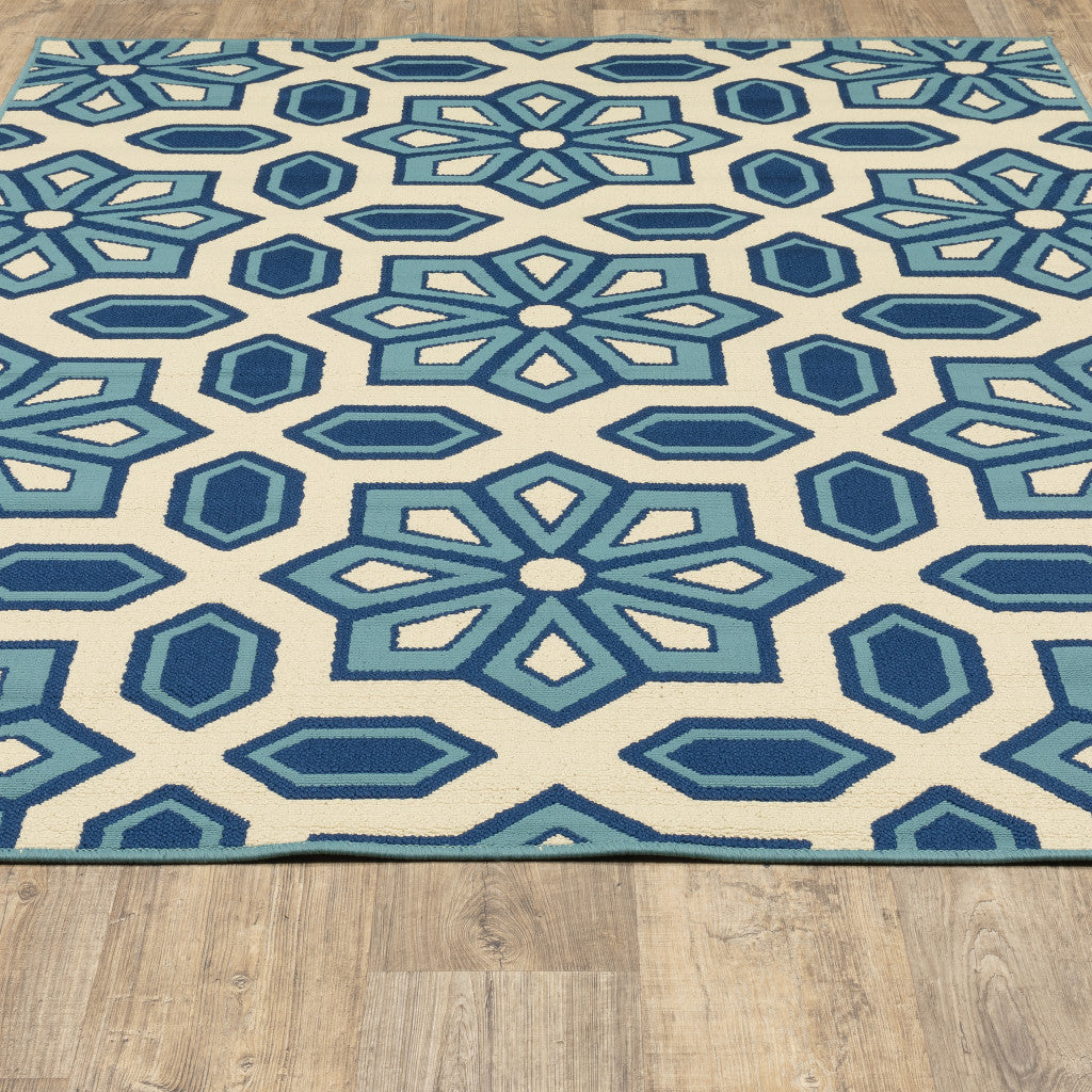 7' x 10' Ivory and Blue Geometric Stain Resistant Indoor Outdoor Area Rug