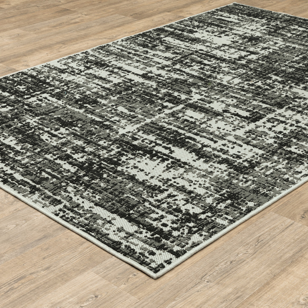 7' x 9' Beige and Black Abstract Stain Resistant Indoor Outdoor Area Rug