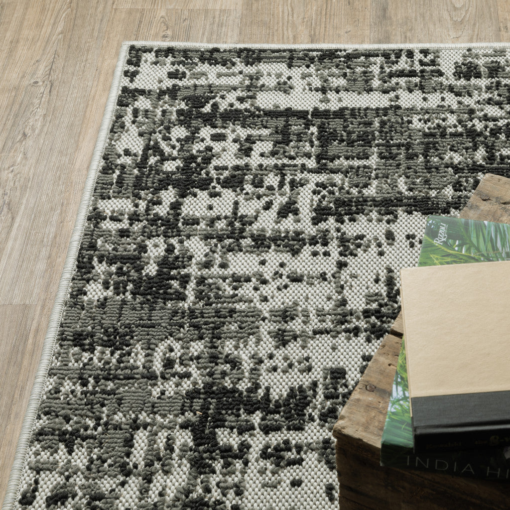 7' x 9' Beige and Black Abstract Stain Resistant Indoor Outdoor Area Rug