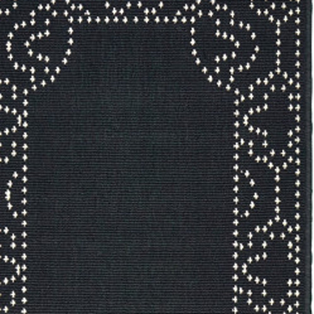 2' X 8' Black and Ivory Stain Resistant Indoor Outdoor Area Rug