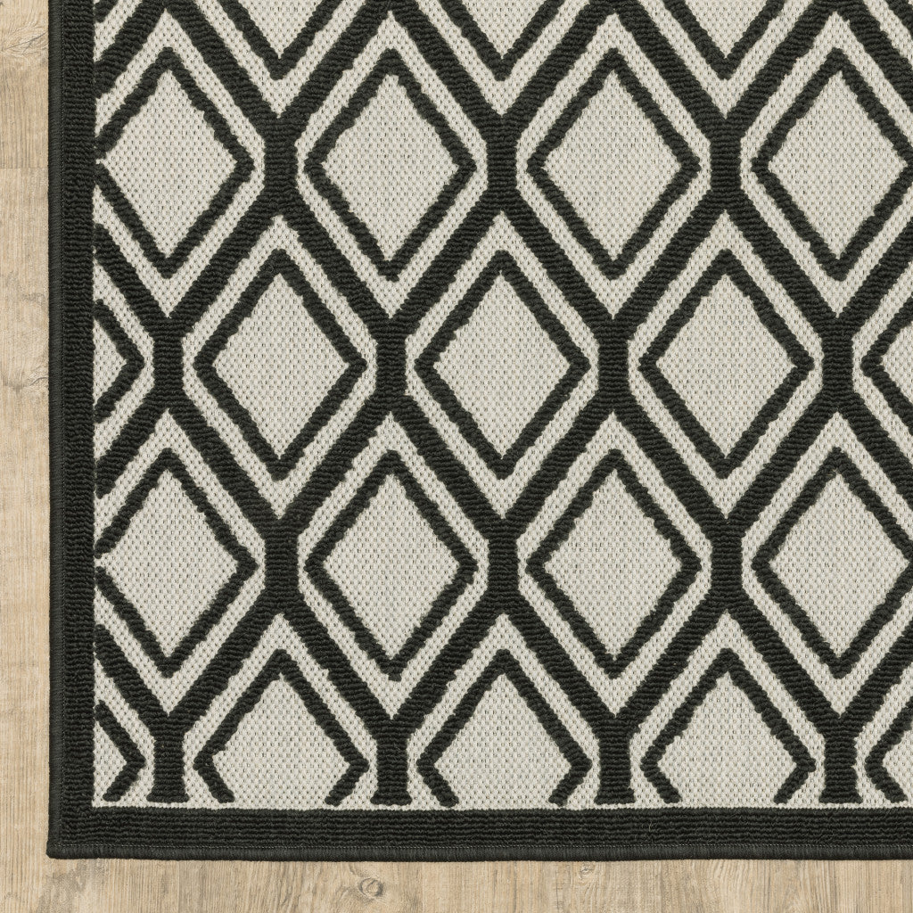 5' x 7' Beige and Black Geometric Stain Resistant Indoor Outdoor Area Rug